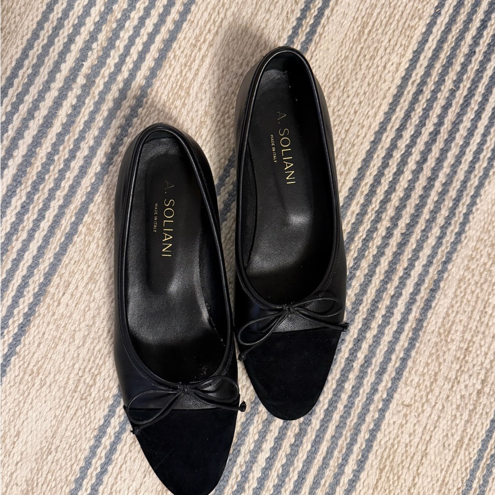 A. Soliani black comp flats. Black leather with suede cap toe.